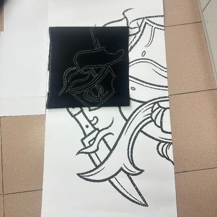 A black fabric with a white Sashiko Stitches outlined showing the matching sketch on the paper.
Done by BabyLock Sashiko BLQK Sewing Machine | Traditional Japanese Hand Stitch Machine. 