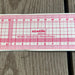 A Kearing No. 8002 Sandwich Line ruler, made of clear plastic with red printed measurement markings and text.
KEARING brand, No 8002, Clear Plastic Straight Ruler, 50cm x 5cm