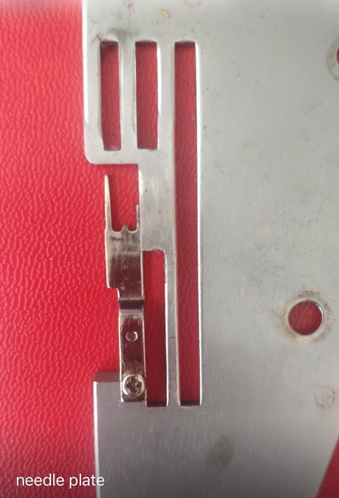 Juki Needle Plate Finger seen broken for a MO-50e, 50eN, 51eN Overlock Sewing Machine, looking from the bottom side.