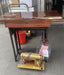 A vintage PFAFF sewing machine, Model 60, mounted on a wooden table with a treadle base. Sent for restoration at Sewing.sg