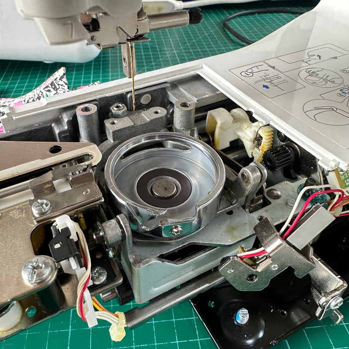 Close-up of the internal mechanism of a sewing machine, Outer Rotary Hook Assembly XC4141121 | NV180 & NV800E & NV2600-BanSoon Sewingat.